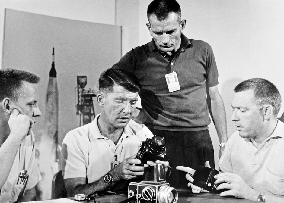Walter Schirra expains Hasselblad Photography to the other Astronauts.jpg