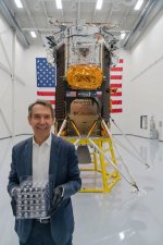 Jeff Koons poses with his moon-bound artwork.jpg