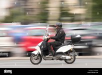 belgrade-serbia-june-24-2018-panning-shot-of-elderly-long-beard-biker-riding-his-scooter-on-ci...jpg