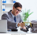 busy-employee-chained-his-office-600w-1511121578.jpg