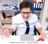 employee-attached-chained-his-desk-260nw-1612576525.jpg